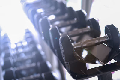 Close-up of dumbbells in row at gym