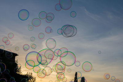 Low angle view of bubbles against sky