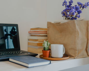 Potted plant on table at home for work from home during coronavirus situation 