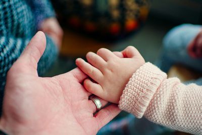 Extreme close up of hand holding baby hand