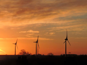 Silhouette of wind turbines at sunset