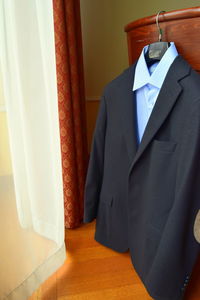 Close-up of clothes hanging on curtain