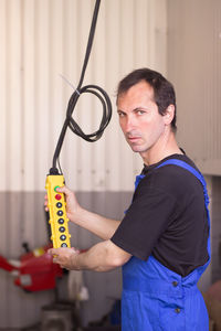 Side view of man holding toy blocks