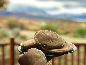 Close-up of hand holding rock outdoors