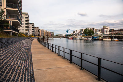 Bridge over river against buildings in city