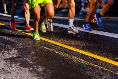 Low section of people running on road