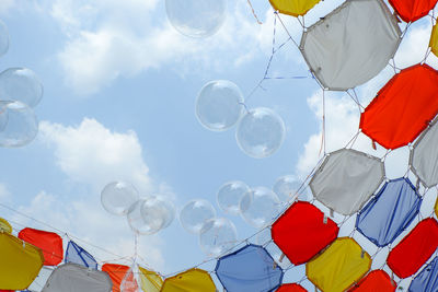 Low angle view of balloons against sky