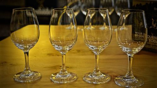 Close-up of wineglasses on wooden table