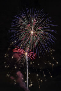 Low angle view of firework display at night