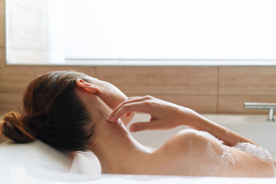 Woman lying down in bathroom