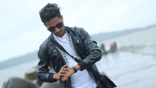 Young man wearing sunglasses standing outdoors