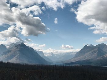 Scenic view of snowcapped mountains against cloudy sky