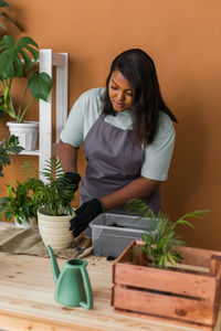 Side view of young woman gardening at farm