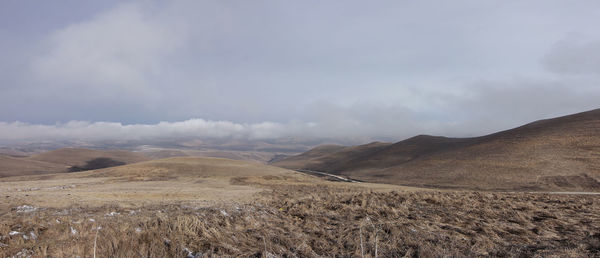 Scenic view of arid landscape against sky