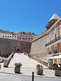 Buildings against clear blue sky in city