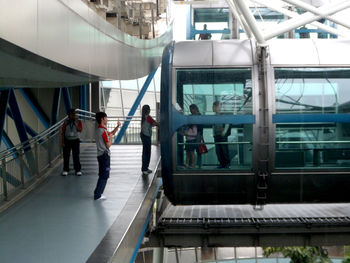 People walking on railroad station platform