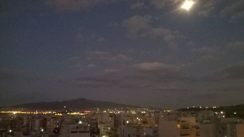 Illuminated cityscape against sky at night