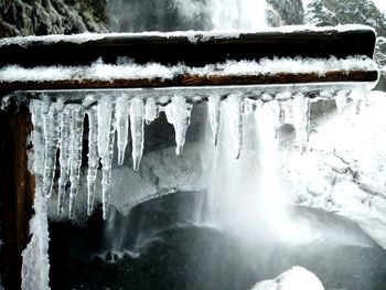 Close-up of icicles against waterfall during winter