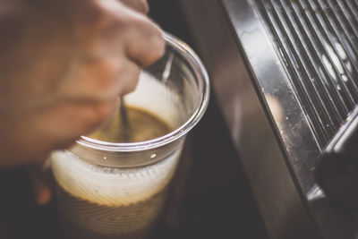 Close-up of hand holding tea cup