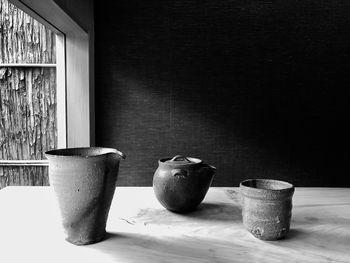 Close-up of potted plant on table against wall