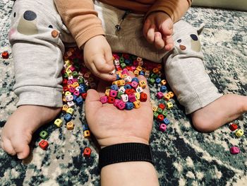 Low section of woman playing with baby