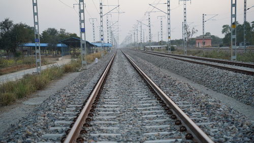 Railway tracks, in the countryside near the station, are seen straight against a blurred background 