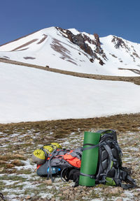 Camping gear, rucksacks, paddles,  folded camping tent are positioned against mountain of erciyes