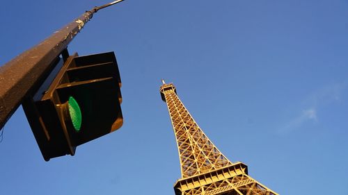 Low angle view of eiffel tower against blue sky