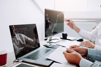 Midsection of business people working on table