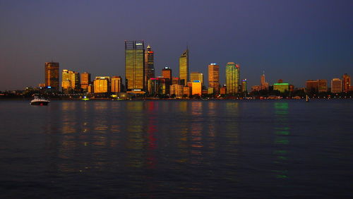 Illuminated city at waterfront