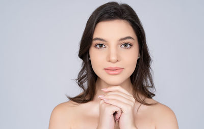 Portrait of a beautiful young woman over white background