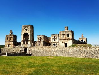 Old ruins of building against clear blue sky