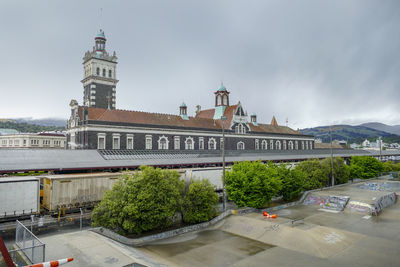 Buildings in city against cloudy sky