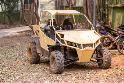 A yellow buggy is parked.