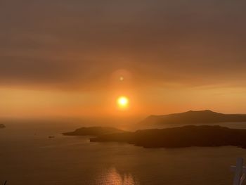 Scenic view of sea against orange sky