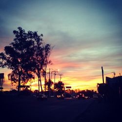 Silhouette of trees against sky at sunset