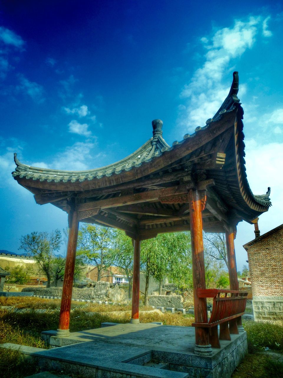 built structure, architecture, sky, building exterior, cloud - sky, place of worship, tree, blue, sunlight, history, day, outdoors, temple - building, religion, low angle view, spirituality, gazebo, architectural column, cloud, travel destinations