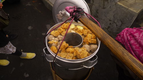 High angle view of food in container hanging from bamboo