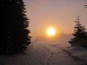 Scenic view of snow against sky during sunset