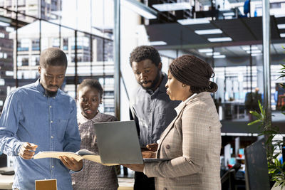 Rear view of business colleagues working at office