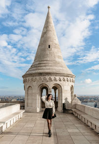 Girl standing on walls in front of spire at fisherman's bastion in budapest, hungary