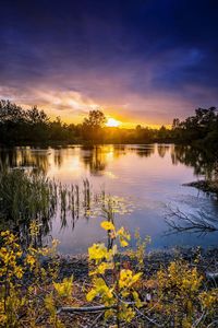 Scenic view of lake against sky during sunset