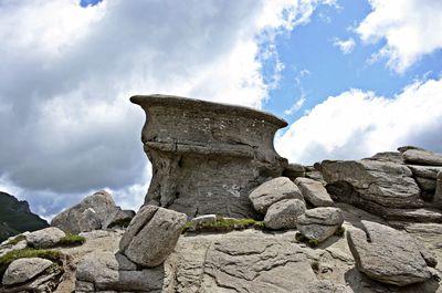 Low angle view of rock formations against sky