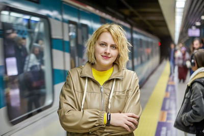 Portrait of woman standing on train at subway station