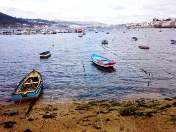 Boats moored on sea against sky