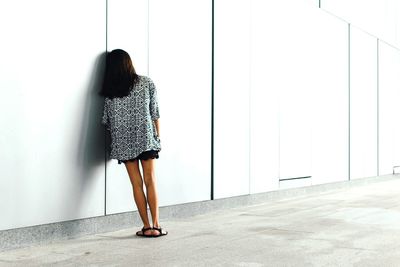 Low section of woman standing on tiled floor