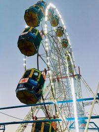 Low angle view of ferris wheel against sky