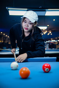 Portrait of woman playing pool