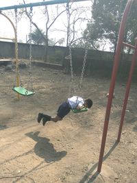 Boy on swing at playground