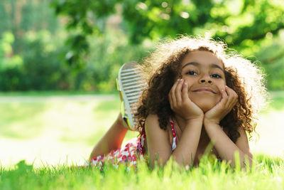 Portrait of young woman sitting on grass